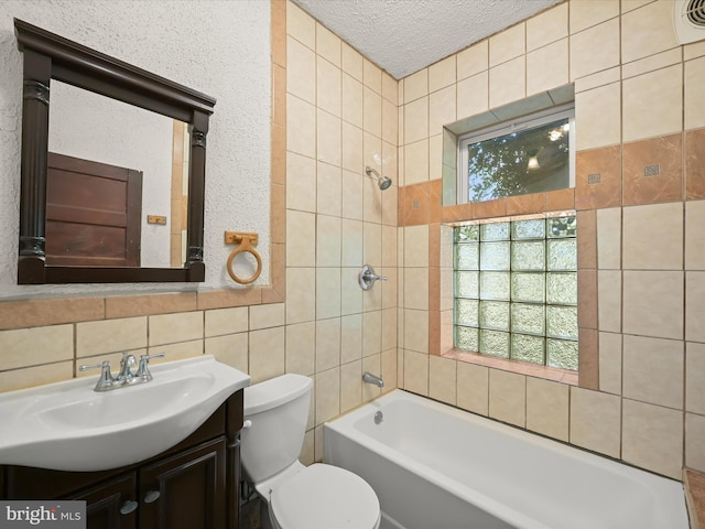 1812 64th Ave, Landover, MD 20785 - bathroom featuring tile walls, vanity, toilet,  shower combination, and a textured ceiling