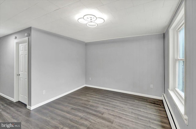613 Minor St, Reading, PA 19602 - spare room featuring a baseboard radiator, dark wood-style flooring, plenty of natural light, and baseboards