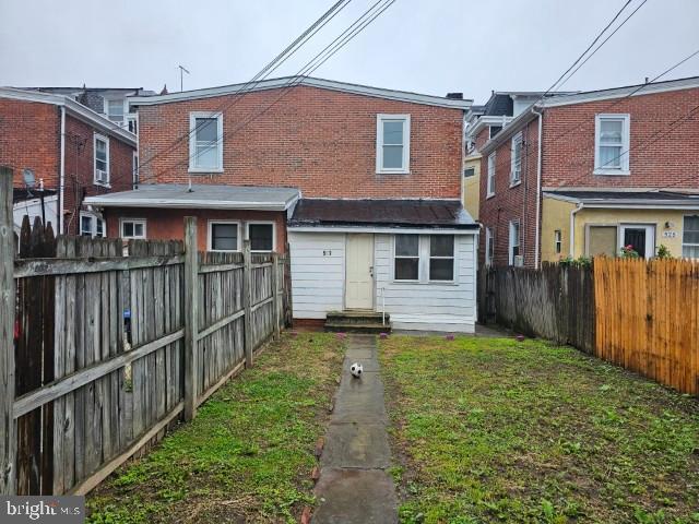 back of house with entry steps and brick siding