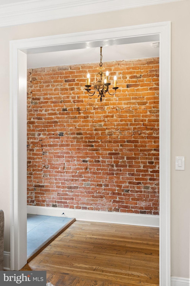 429 Manor Pl NW, Washington, DC 20010 - hall featuring a chandelier, baseboards, wood finished floors, and brick wall