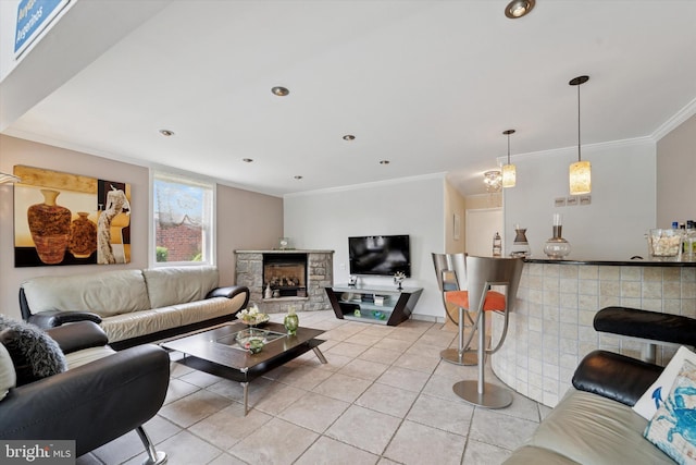 living room with light tile patterned floors, crown molding, and a fireplace