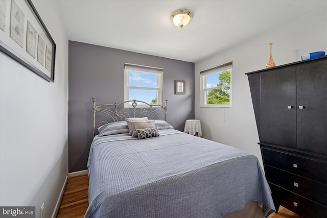 bedroom with wood finished floors and baseboards