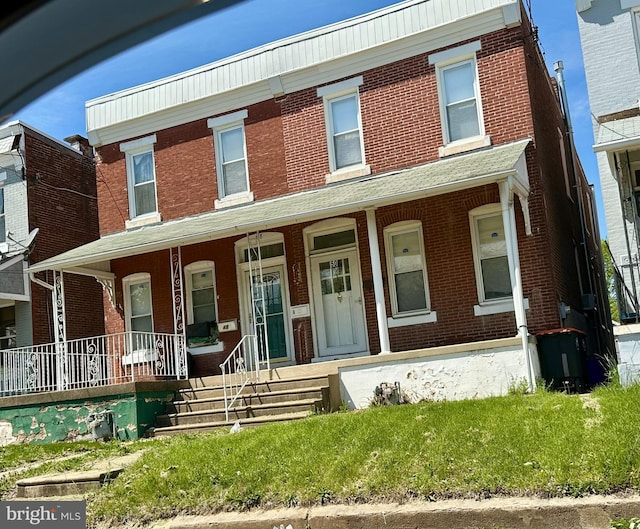 48 E 22 Nd St, Chester, PA 19013 - townhome / multi-family property with brick siding and covered porch