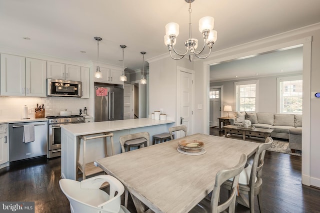 2 Murdock Rd, Baltimore, MD 21212 - dining room featuring ornamental molding, a chandelier, and dark wood-style flooring