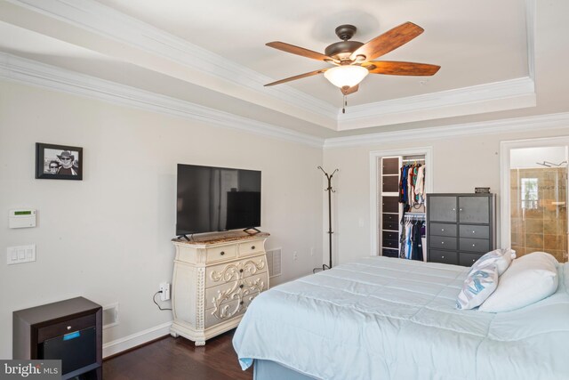 21 Whaleback Ln, Fredericksburg, VA 22406 - bedroom with crown molding, a walk in closet, dark wood finished floors, a tray ceiling, and a closet