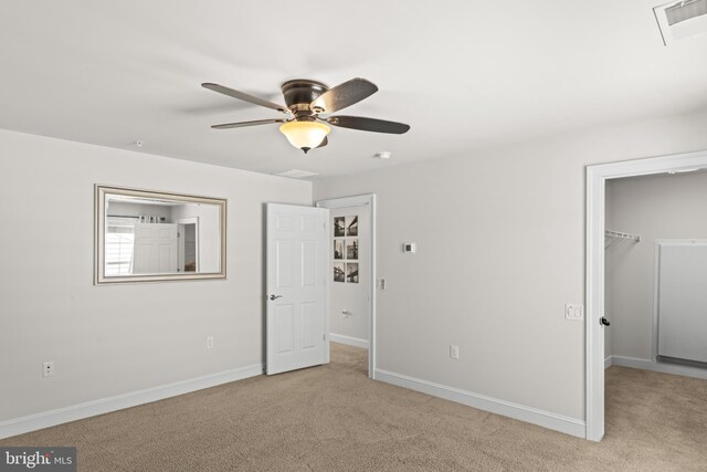 21 Whaleback Ln, Fredericksburg, VA 22406 - unfurnished bedroom featuring light carpet, a walk in closet, baseboards, a closet, and a ceiling fan