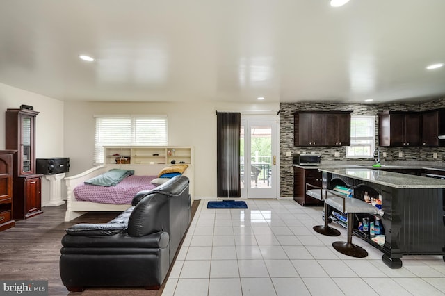 1533 Meadowview Dr, Pottstown, PA 19464 - kitchen featuring healthy amount of natural light, dark brown cabinets, recessed lighting, a sink, and light stone countertops