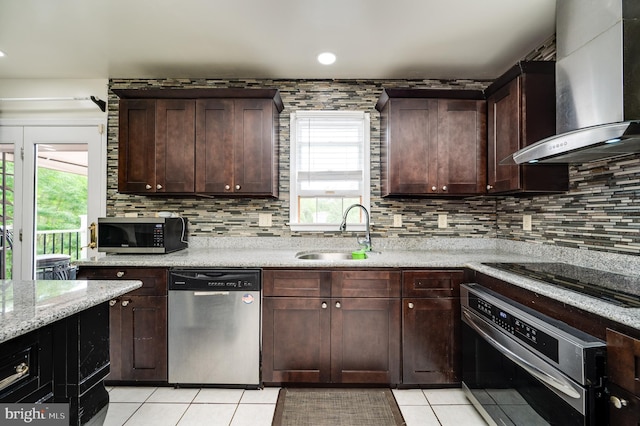 1533 Meadowview Dr, Pottstown, PA 19464 - kitchen featuring stainless steel appliances, wall chimney range hood, light tile patterned floors, a sink, and backsplash