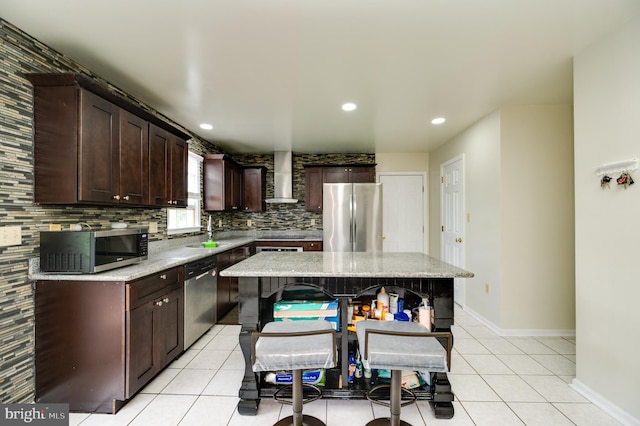 1533 Meadowview Dr, Pottstown, PA 19464 - kitchen with appliances with stainless steel finishes, wall chimney range hood, decorative backsplash, dark brown cabinets, and light tile patterned flooring