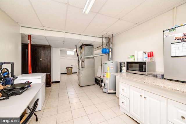 1533 Meadowview Dr, Pottstown, PA 19464 - finished below grade area featuring gas water heater, a drop ceiling, heating unit, and light tile patterned flooring
