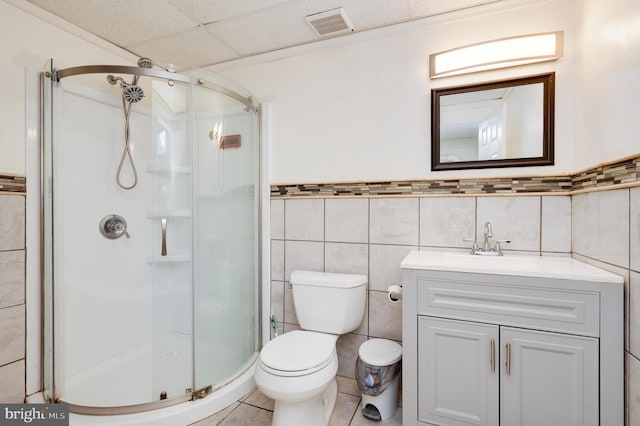 1533 Meadowview Dr, Pottstown, PA 19464 - full bathroom featuring tile walls, a stall shower, a drop ceiling, vanity, and toilet