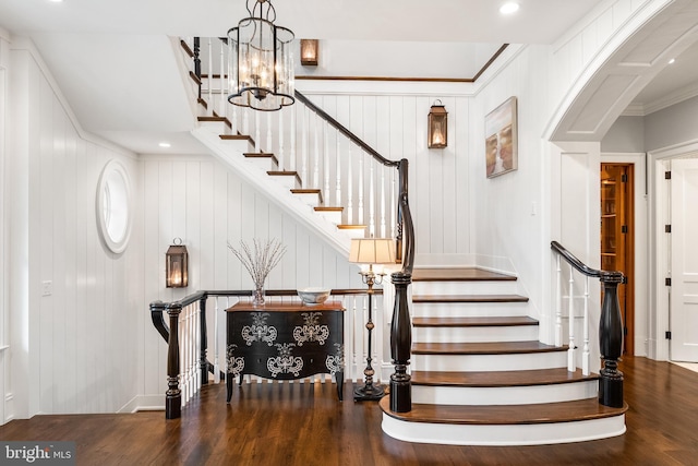 6529 Sothoron Rd, Mclean, VA 22101 - staircase featuring wood finished floors, a chandelier, arched walkways, a decorative wall, and recessed lighting