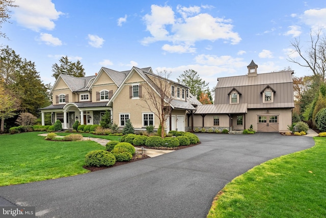 6529 Sothoron Rd, Mclean, VA 22101 - view of front of home featuring a standing seam roof, metal roof, asphalt driveway, a front yard, and covered porch