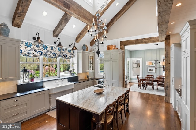 6529 Sothoron Rd, Mclean, VA 22101 - kitchen with high vaulted ceiling, dark wood-style floors, decorative backsplash, beamed ceiling, and an island with sink