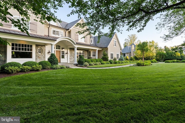 6529 Sothoron Rd, Mclean, VA 22101 - shingle-style home featuring stone siding, a standing seam roof, a front yard, and metal roof