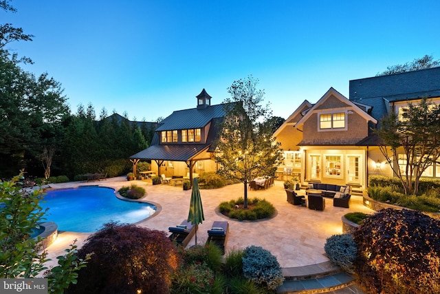 6529 Sothoron Rd, Mclean, VA 22101 - rear view of property with an outdoor hangout area, a patio, a standing seam roof, an outdoor pool, and metal roof