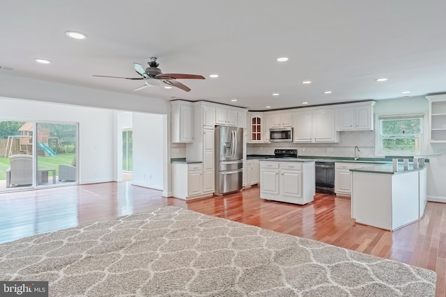 5923 Westridge Ct, Alexandria, VA 22310 - kitchen with black appliances, light wood-style floors, recessed lighting, white cabinets, and a ceiling fan