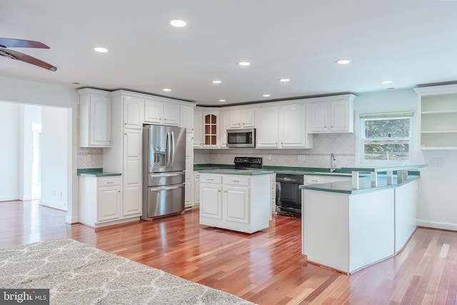 5923 Westridge Ct, Alexandria, VA 22310 - kitchen featuring black appliances, white cabinetry, a sink, ceiling fan, and a peninsula