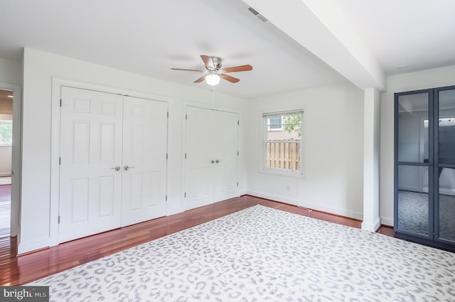 5923 Westridge Ct, Alexandria, VA 22310 - unfurnished bedroom featuring wood finished floors, two closets, baseboards, and ceiling fan