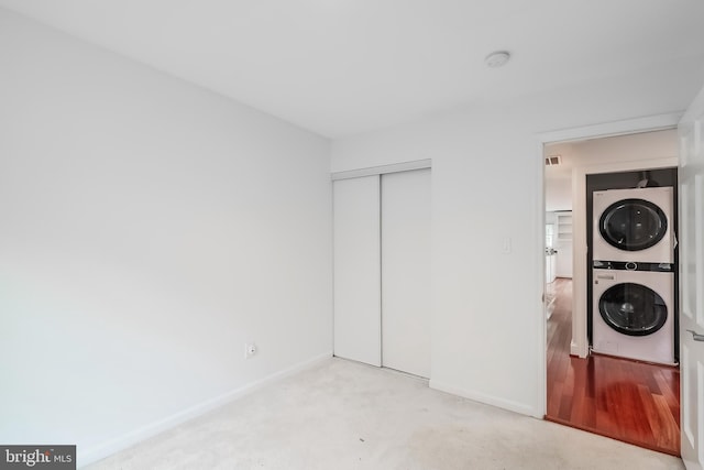 5923 Westridge Ct, Alexandria, VA 22310 - laundry room with stacked washer / dryer, baseboards, light colored carpet, and elevator