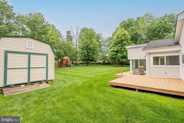 5923 Westridge Ct, Alexandria, VA 22310 - view of grassy yard with a wooden deck, a playground, and view of wooded area