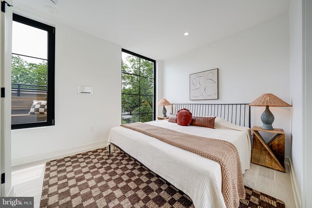 2907 Newark St NW, Washington, DC 20008 - bedroom featuring a wall of windows, baseboards, wood finished floors, and recessed lighting