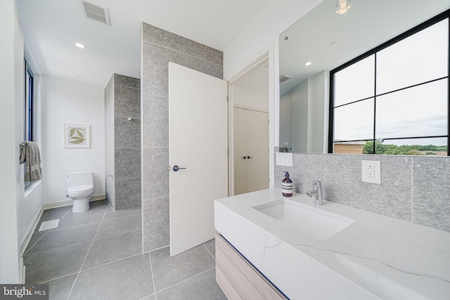 2907 Newark St NW, Washington, DC 20008 - bathroom with tile patterned floors, toilet, vanity, recessed lighting, and tasteful backsplash
