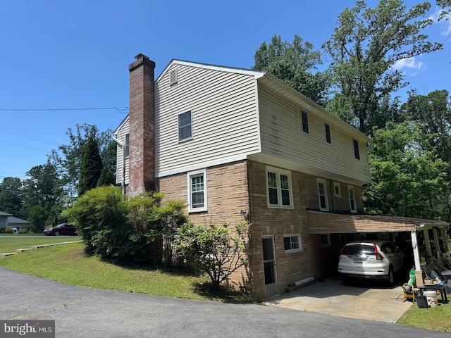 3901 Glenbrook Rd, Fairfax, VA 22031 - view of side of home featuring concrete driveway, a chimney, stone siding, a carport, and a lawn