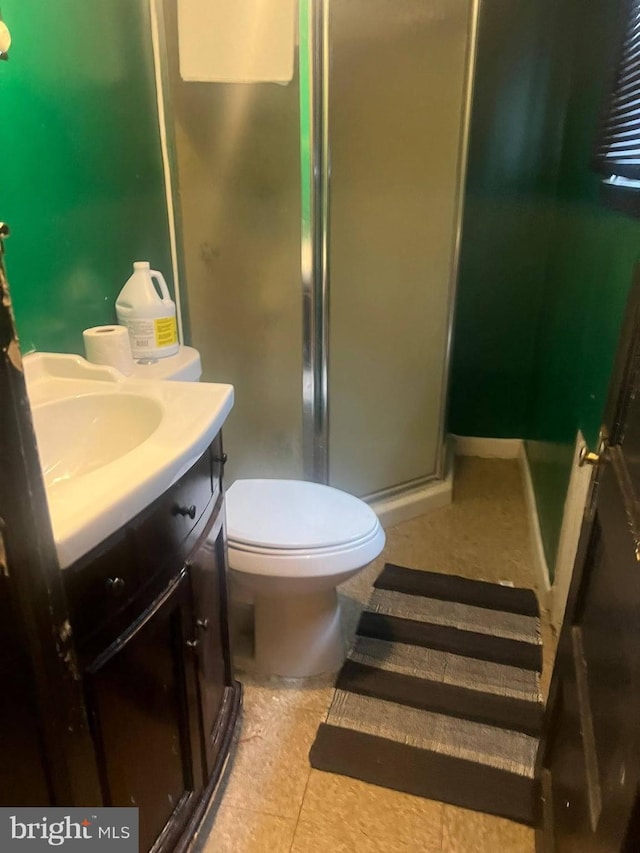 full bathroom featuring a shower stall, tile patterned floors, vanity, and toilet