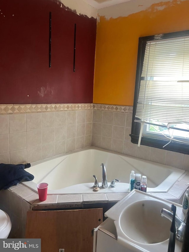 full bath with a sink and a bath