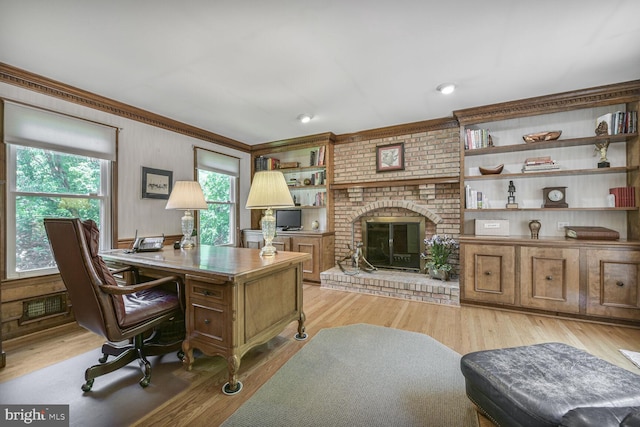 981 Old Holly Dr, Great Falls, VA 22066 - home office featuring crown molding, a fireplace, and light wood finished floors