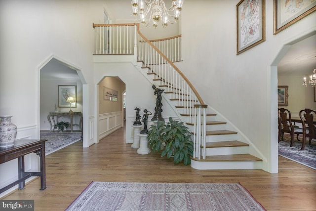 981 Old Holly Dr, Great Falls, VA 22066 - entryway with a chandelier, stairway, a high ceiling, wood finished floors, and arched walkways