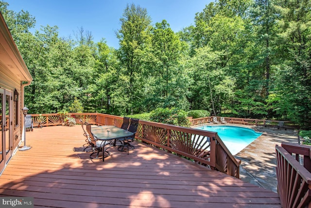 981 Old Holly Dr, Great Falls, VA 22066 - wooden deck featuring an outdoor pool, outdoor dining space, and a wooded view