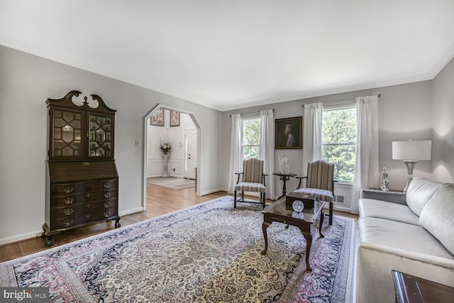 981 Old Holly Dr, Great Falls, VA 22066 - living area with crown molding, wood finished floors, arched walkways, and baseboards