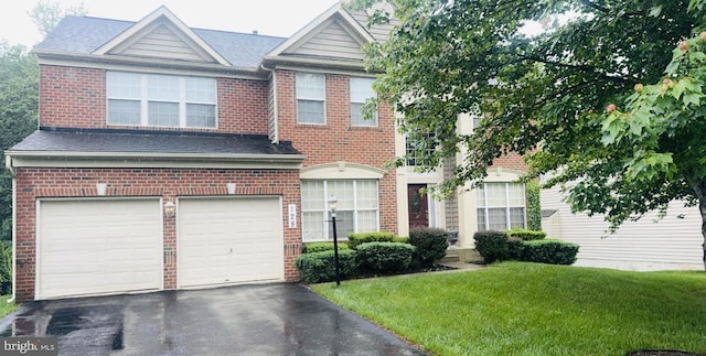 128 Bay Club Pkwy, North East, MD 21901 - view of front of property featuring a garage, brick siding, asphalt driveway, and a front lawn