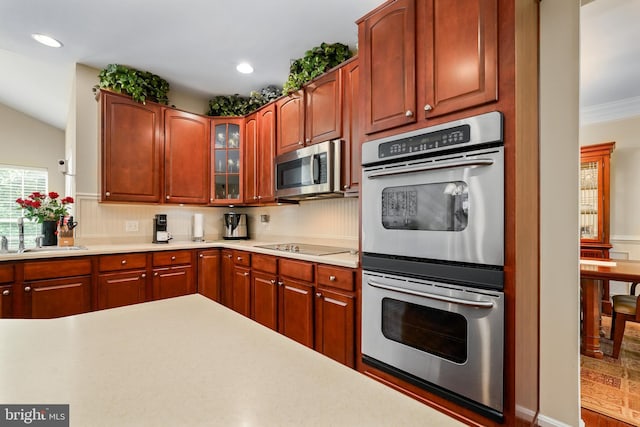 128 Bay Club Pkwy, North East, MD 21901 - kitchen featuring stainless steel appliances, a sink, light countertops, glass insert cabinets, and crown molding