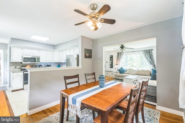 241 Fenwick Rd, Woodstown, NJ 08098 - dining room with ceiling fan, light wood-style flooring, and baseboards