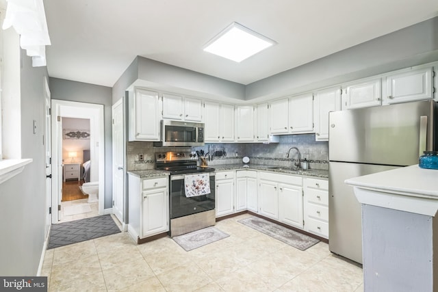 241 Fenwick Rd, Woodstown, NJ 08098 - kitchen featuring stainless steel appliances, a sink, backsplash, and white cabinetry