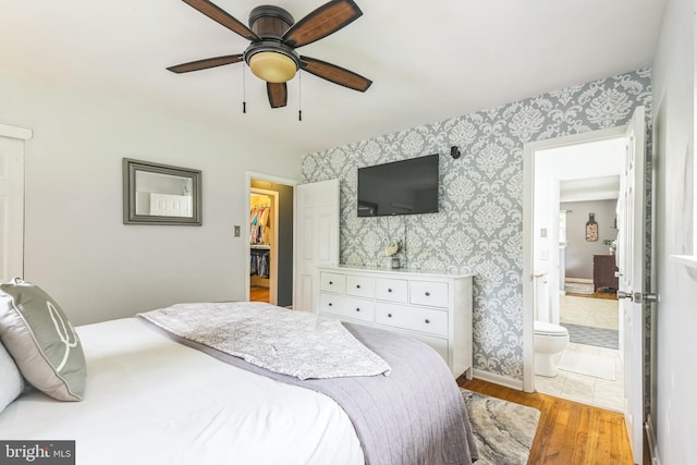 241 Fenwick Rd, Woodstown, NJ 08098 - bedroom with wallpapered walls, wood finished floors, baseboards, ensuite bath, and a ceiling fan