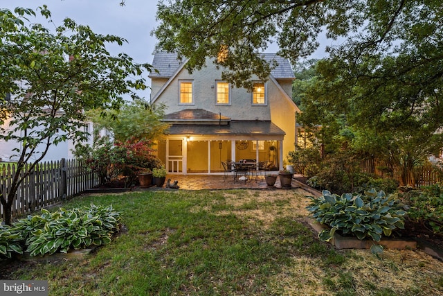 4404 Eastway, Baltimore, MD 21218 - back of house with roof with shingles, a patio, stucco siding, and a sunroom