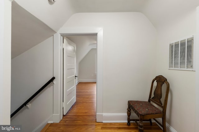 4404 Eastway, Baltimore, MD 21218 - hall with lofted ceiling, light wood-style floors, baseboards, and an upstairs landing