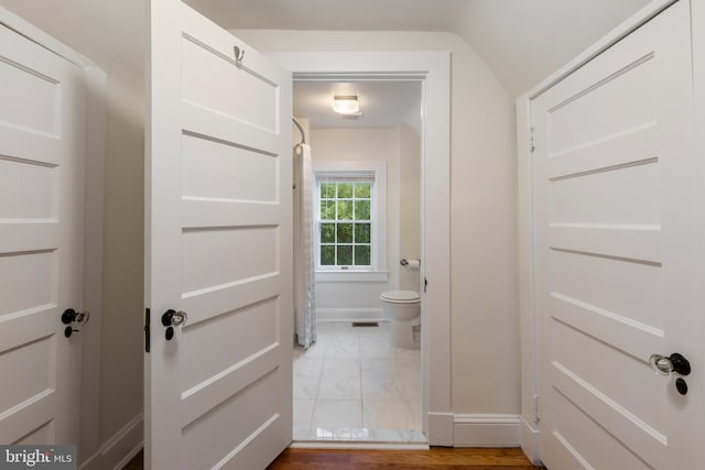 4404 Eastway, Baltimore, MD 21218 - bathroom featuring baseboards, marble look tile flooring, and toilet