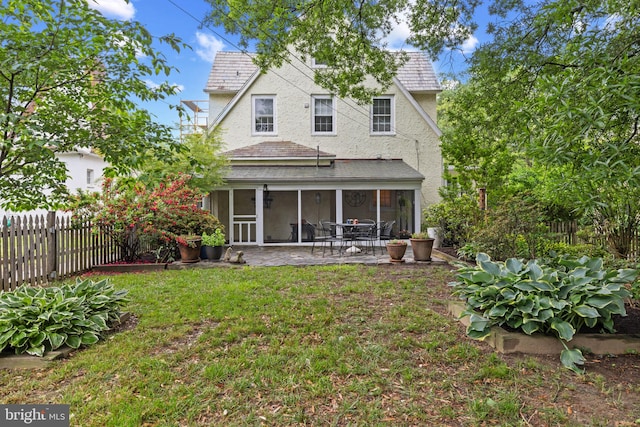 4404 Eastway, Baltimore, MD 21218 - rear view of house with a sunroom, stucco siding, a patio, and a shingled roof