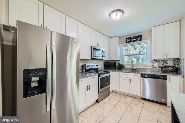 1201 Cobb Rd, Baltimore, MD 21208 - kitchen featuring appliances with stainless steel finishes, a sink, backsplash, and white cabinets