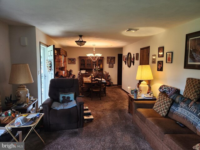 carpeted living area featuring a chandelier