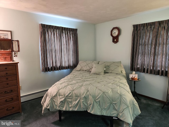 bedroom with a baseboard heating unit, carpet flooring, and baseboards