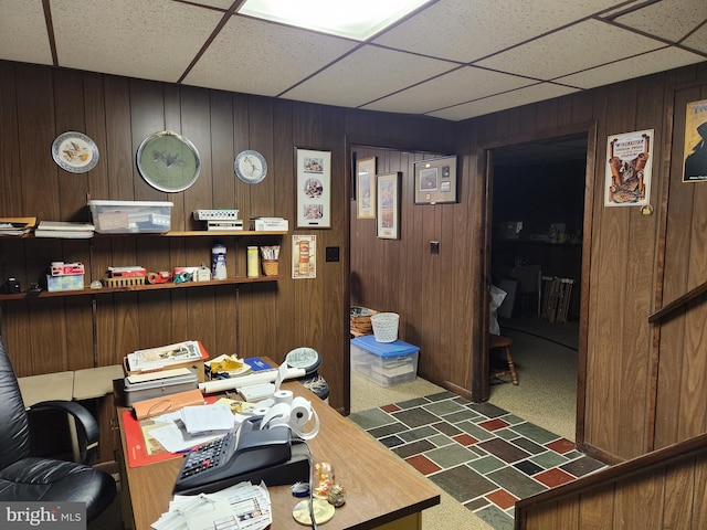 home office featuring wooden walls and a paneled ceiling