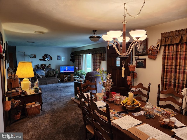 dining area with carpet flooring and a chandelier