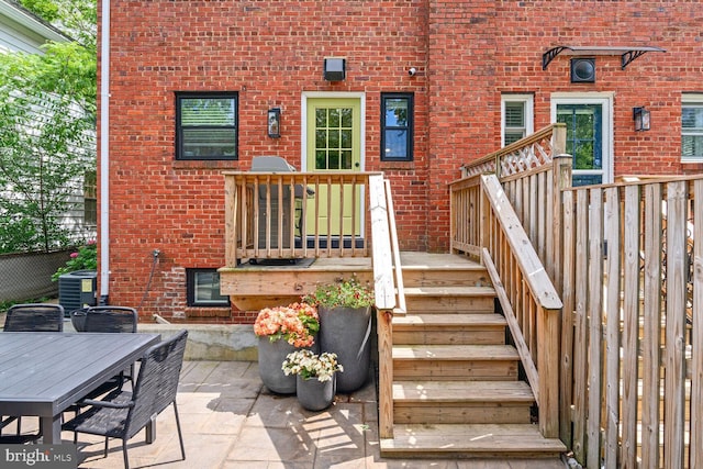 16 E Monroe Ave, Alexandria, VA 22301 - entrance to property with brick siding, outdoor dining space, central air condition unit, and a patio area
