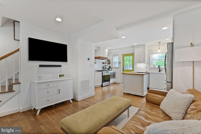 16 E Monroe Ave, Alexandria, VA 22301 - living room with light wood-style flooring, stairs, recessed lighting, and baseboards